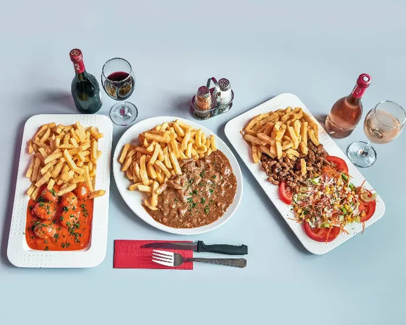 Drie schotels van Frituur Drie Koningen: balletjes in tomatensaus, stoofvlees en pittaschotel met verse frieten